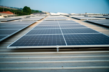 Solar panels on factory roof photovoltaic solar panels absorb sunlight as a source of energy to...