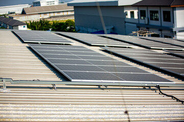Solar Panel Photovoltaic installation on a Roof of factory, sunny blue sky background, alternative electricity source - Sustainable Resources Concept.