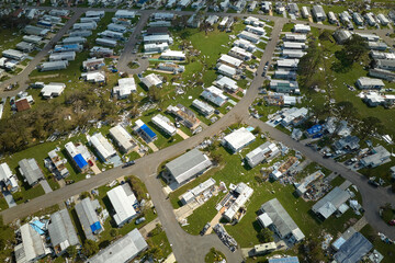Badly damaged mobile homes after hurricane Ian in Florida residential area. Consequences of natural...