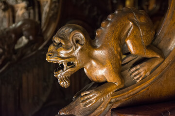 Detail of a gargoyle carved in the wood of the choir seats of Toledo Cathedral, Spain.