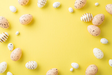 Fototapeta na wymiar Easter decor concept. Top view photo of light pink white and gold quail eggs on isolated yellow background with copyspace in the middle