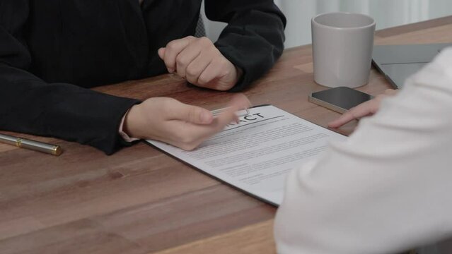 Closeup young enthusiastic businesswoman negotiate financial business contract in the office. Client making deal with professional manager at corporate office. Business lawyer making legal paperwork.