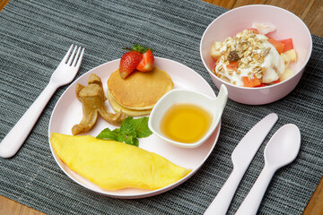 Kids menu - omlet, pancakes with maple syrup, muesli with yoghurt and glass of fresh squuzed orange...