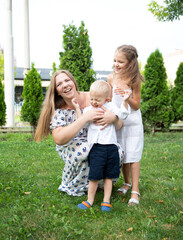 Obraz premium People laugh emotionally. Mom children have fun together.