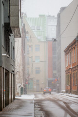 Narrow streets in Riga, Latvia during winter and heavy snow fall. Vertical photo