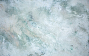 Green background from decorative plaster with abstract spots. Unusual green wall texture with beautiful patterns, creative surface background. Front covering for facing of buildings.