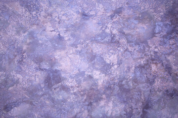 Background from decorative plaster with abstract patterns and stains. Fancy red and pink decoration wall texture, creative purple surface background. Finishing coating for building cladding.