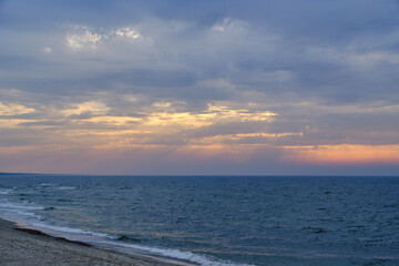 Sunset on shore sandy beach Baltic Sea.