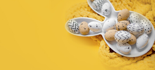 creative easter layout with white plate bunny and easter eggs on yellow background. copy space. top...