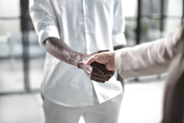 Handshake in a modern office between partners