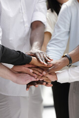Pile of business partners hands, Interracial communications