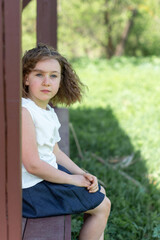 Obraz premium A girl in a white blouse walks in the park after school