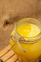 Homemade ghee Pure desi ghee in a bowl with wooden spoon, Healthy fats, clean eating for weight loss. place for text, top view