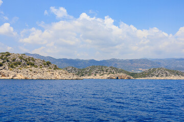 View of the rocky shore from the sea. Mediterranean Sea in Turkey. Popular tourist places. Background