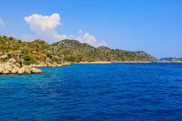 View of the rocky shore from the sea. Mediterranean Sea in Turkey. Popular tourist places. Background