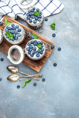 Fototapeta na wymiar Parfait with blueberry, Delicious chocolate mousse or pudding with whipped cream. vertical image. top view. place for text