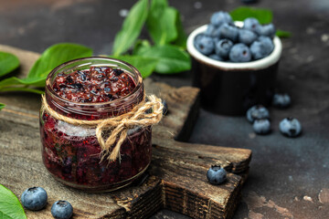 Blueberry jam or marmelade in glass. Blueberries fruits. place for text, top view