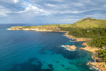 Aerial photographs of the beaches of Cala Xarraca , on the island of Ibiza during a sunny summer day with blue sky and turquoise water