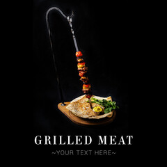Portion of meat dish shashlik with vegetables served on skewer. Grilled meat with mustard sauce,...