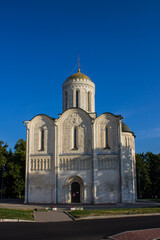 VLADIMIR, Russia - AUGUST, 17, 2022: old white-stone Dmitrievsky Cathedral with a golden dome close-up on a sunny summer day