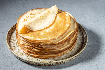 Thin crepes on a plate. Delicious breakfast or dessert. place for text