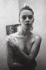 Young woman in the shower, water drops.