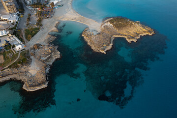Aerial drone view of the coastline of empty beach in winter. Summer holidays. Nissi beach bay Ayia Napa, Cyprus