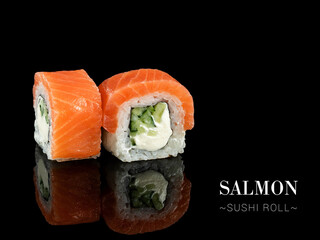 Close up to inside out sushi roll pieces with mirror reflection on black background. Sushi roll with cream cheese, cucumber and salmon on top. Ready menu advertising banner with text and copy space.