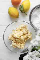 Lemon, orange and ricotta bund cake on a white background