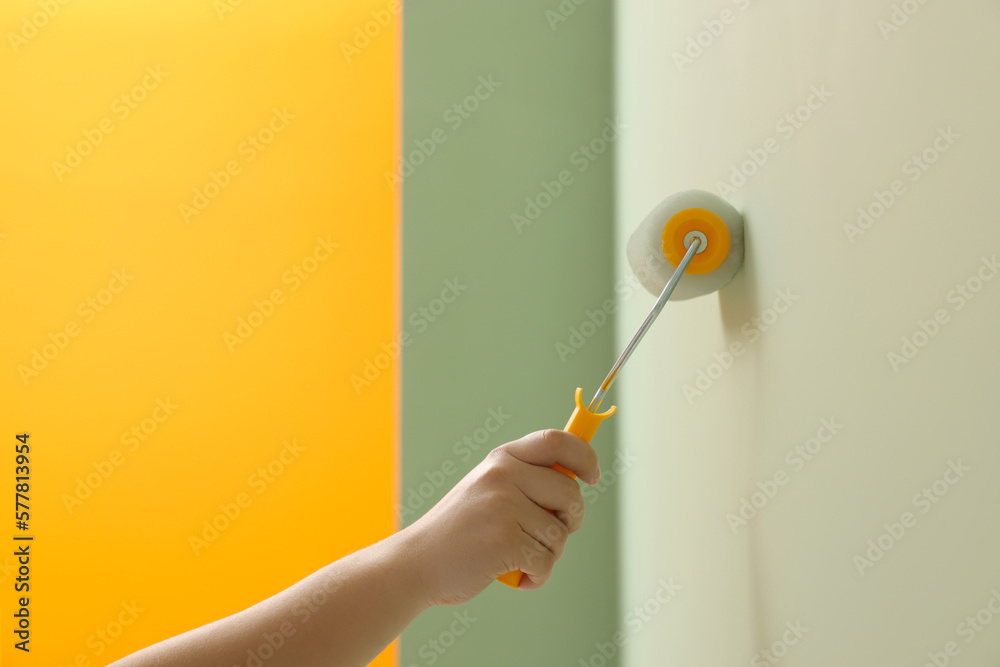 Canvas Prints Worker using roller to paint wall with colorful dye indoors, closeup