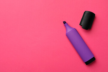 Bright purple marker on pink background, flat lay. Space for text