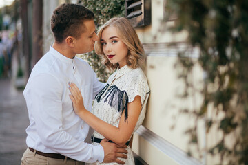 Fototapeta premium Beautiful couple smiling and posing in the city