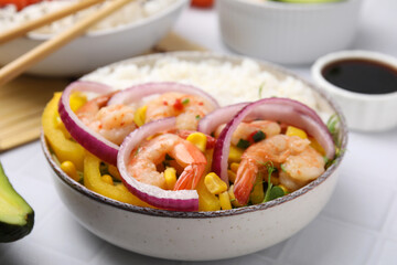 Delicious poke bowl with shrimps, rice and vegetables on white table, closeup