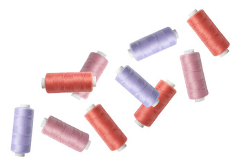 Many colorful sewing threads falling on white background