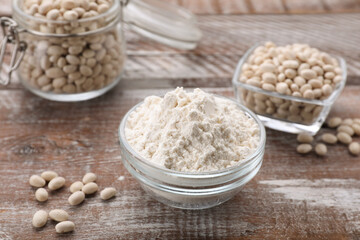 Fototapeta na wymiar Bean flour and seeds on wooden table