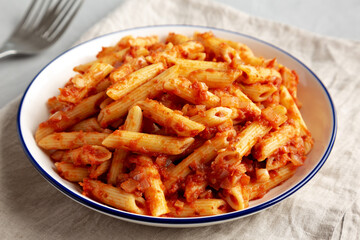 Homemade Penne With Tomato Sauce on a Plate, side view. Close-up.