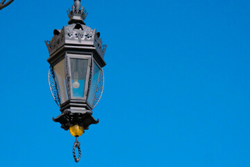 Fototapeta na wymiar Antique vintage street lamp against the blue sky, background