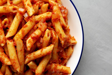 Homemade Penne With Tomato Sauce on a Plate, top view. From above, overhead, flat lay. Close-up.
