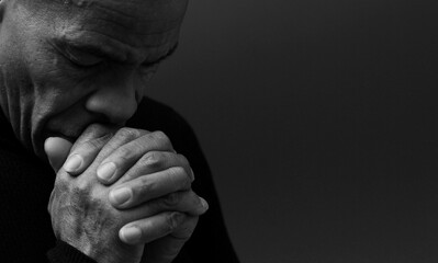 people praying to god at home on black background with people stock photo