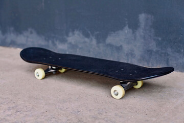 Close up black skateboard on city street urban background © guas