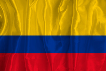 The flag of Colombia on a silk background is a great national symbol. Fabric texture The official state symbol of the country.