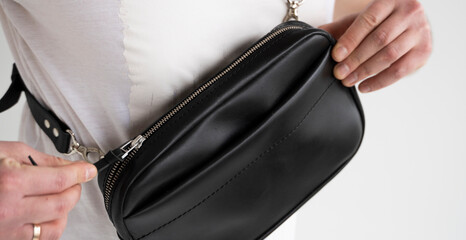 Details of leather black handmade bag over his shoulder. Dark designer banana bag. Comfortable...