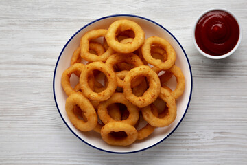 Homemade Breaded Onion Rings with Ketchup on a Plate, top view. Flat lay, overhead, from above.