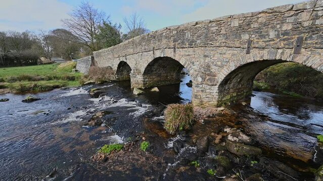old stone bridge running over water at Postbridge in Devon
