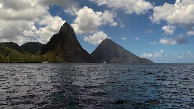 Saint Lucia pitons as seen from the water.  The Pitons are two mountainous volcanic plugs, volcanic spires, located in Saint Lucia. 