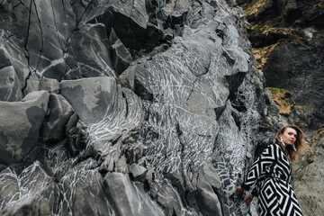the contrast of the texture and the person, a photo of a girl against a rock background