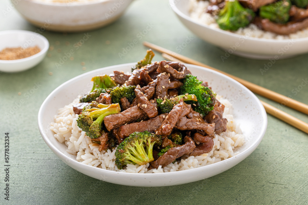 Wall mural beef and broccoli served over rice on a plate