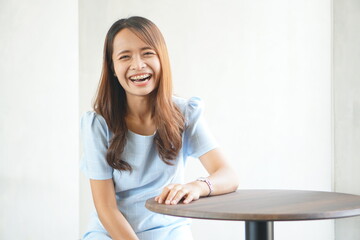 Happy Asian woman in a coffee shop