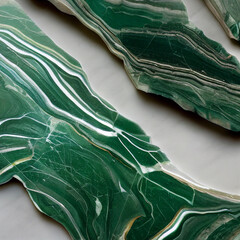 Pieces of green marble with white lines on a light background. Mineral tabletop closeup.