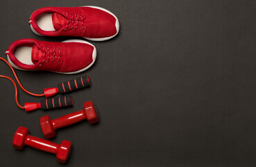 Red sport equipment on color background, top view